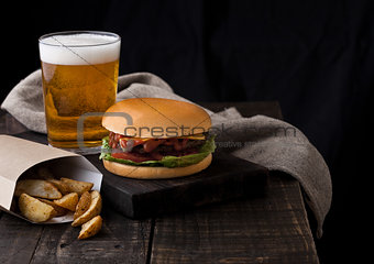 Fresh beef burger with potato wedges and beer