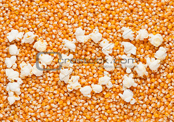 Raw golden sweet corn seeds with word POP