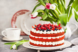 Delicious homemade red velvet cake decorated with cream and fres
