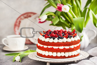 Delicious homemade red velvet cake decorated with cream and fres