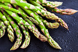 Raw fresh asparagus on dark background, close-up