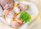Cute baby sleeping with Easter decorations