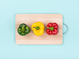 Fresh bell peppers on a chopping board
