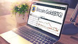 Dynamics of Cost of BITCOIN GOLD on the Laptop Screen. 3d
