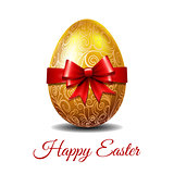 Gold Easter egg tied of red ribbon