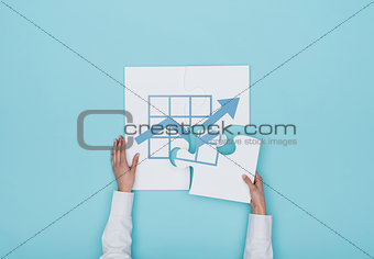 Woman completing a puzzle with a graph icon