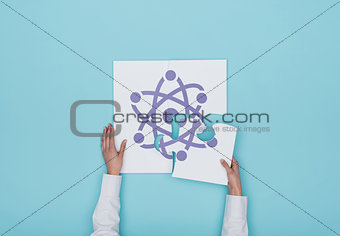 Woman completing a puzzle with atom icon