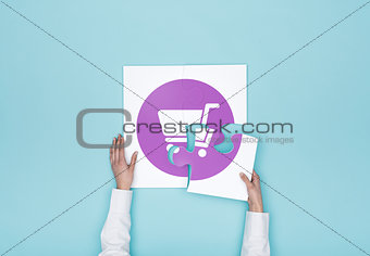 Woman completing a puzzle with a shopping cart icon