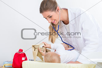 Dedicated pediatrician using the stethoscope during the check-up