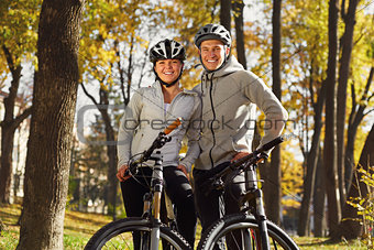 backlight photo of a couple having fun by bike
