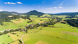 Forest, village and field summer landscape from above - drone view