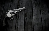 3D handgun on a grunge wooden texture