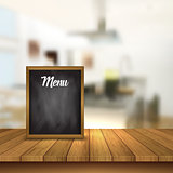 Chalkboard menu on a table against a defocussed cafe interior ba