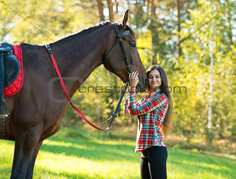 beautiful long hair young woman with a horse outdoor