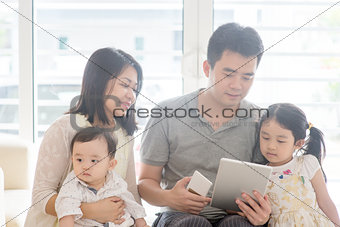 Asian family using tablet and smart phone