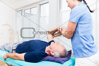 Physio treating senior patient