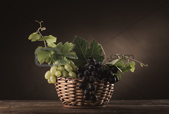 Ripe grapes in a basket still life