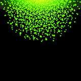 Falling glow green particles on black background.