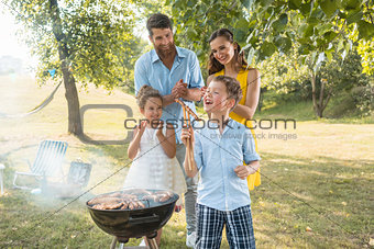 Portrait of happy family with two children outdoors