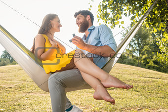 Young man making marriage proposal to beautiful girlfriend