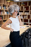 Senior businesswoman making phone call in a meeting room