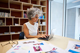 Senior businesswoman working on laptop in office