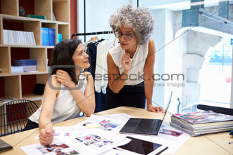 Two female creatives discussing magazine layout, close up