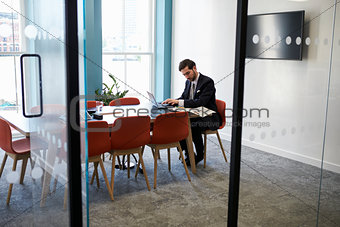 Young businessman working alone in a boardroom