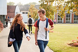 Teenage Students Walking Around College Campus Together
