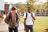Male Teenage Students Walking Around College Campus Together