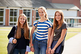 Group Of Female Teenage Students Walking Around College Campus