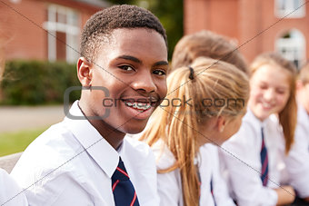 Portrait Of Teenage Students In Uniform Outside School Buildings