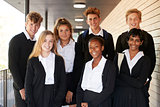 Portrait Of Teenage Students In Uniform Outside School Building