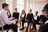 Group Of Teenage Students Having Discussion With Tutor