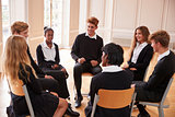 Group Of Teenage Students Having Discussion In Class Together