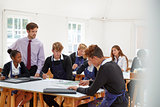 Teenage Students Listening To Teacher In Art Class