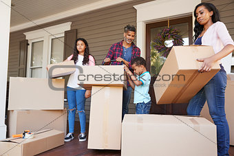 Children Helping Children With Boxes On Moving In Day