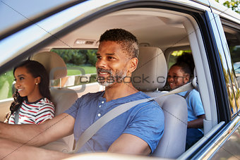 Family In Car Going On Road Trip