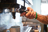 Close Up Of Male Barista Using Coffee Machine In Cafe