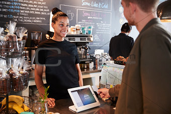 Customer Paying In Coffee Shop Using Credit Card