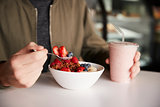 Close Up Of Man Eating Healthy Breakfast Of Granola In Cafe