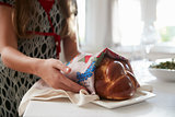 Girl covering challah bread for Shabbat meal, close up