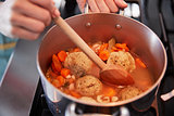 Close up of woman cooking Jewish matzon ball soup