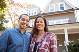 Portrait Of Smiling Couple Standing In Front Of Their Home