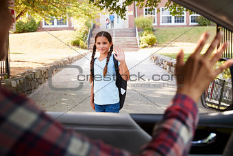Mother In Car Dropping Off Daughter In Front Of School Gates