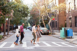 Group Of Friends Crossing Urban Street In New York City