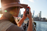Tourist Taking Photo Of Manhattan Skyline On Mobile Phone