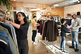 Customers and staff in a busy clothes shop