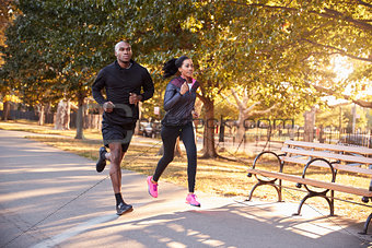 Young black couple jogging in a Brooklyn park