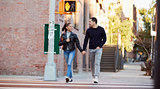 Young Hispanic couple walking hand in hand in Brooklyn